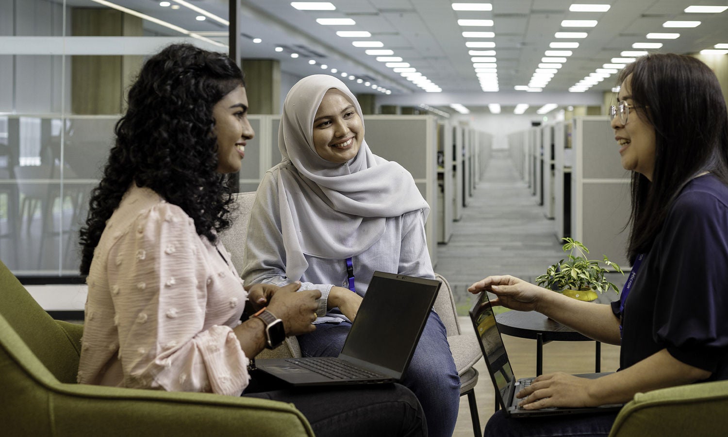 Three woman sitting and talking in office building 